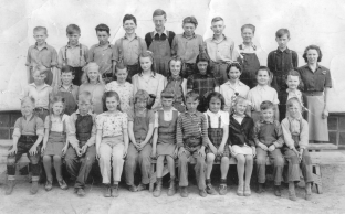 Record ID PIC1597251493. Rosebud School 1945. Delbert Fulkerth, Werner Rhinehardt, Roland Mullen, Edward Irwin, Walter Scheidt, Bob Fulkerth, Jack Mooney, Fitz Torpe, Earl Scheuer, Mrs. Eubank, Ivan Mooney, Donald Irwin, Annie Rhinehardt, Peggy Fulkerth, Shirley Wilson, Adrianne Scheidt, Betty Fulkerth, Vera Irwin, Norma Scheuer, Mary Ann Wilson, Milo Torpe, Myrna Scheuer, Jean Mooney, Robert Mooney, Gwen Brady